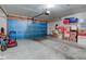 Spacious garage featuring a blue garage door, an automatic door opener, and room for storage at 741 Chestnut Ln, Brownsburg, IN 46112