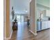 Open-concept floor plan with hardwood floors connecting the kitchen, dining area, and living room, enhanced by natural light at 741 Chestnut Ln, Brownsburg, IN 46112