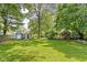 Spacious backyard with mature trees and lush lawn at 7651 Sherry Ln, Brownsburg, IN 46112