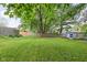 Lush backyard featuring a large, well-maintained lawn surrounded by mature trees at 7651 Sherry Ln, Brownsburg, IN 46112