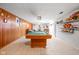 Finished basement with wood paneling, tile floor, and a pool table ready for entertainment at 7651 Sherry Ln, Brownsburg, IN 46112