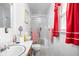 Compact bathroom featuring a white vanity, toilet, and shower with sliding glass doors, offering functionality at 7651 Sherry Ln, Brownsburg, IN 46112