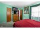 Bedroom featuring a bed with red bedding, neutral carpet, and ample closet space at 7651 Sherry Ln, Brownsburg, IN 46112