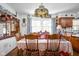 Inviting dining room showcasing a wooden dining set, a decorative light fixture, and bright natural light at 7651 Sherry Ln, Brownsburg, IN 46112