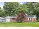 Charming single-story brick home featuring an attached garage and a well-maintained front yard and patriotic decor at 7651 Sherry Ln, Brownsburg, IN 46112