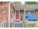 Inviting brick front porch with decorative accents including a wooden railing, potted plants, and charming decor at 7651 Sherry Ln, Brownsburg, IN 46112