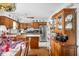 Well-equipped kitchen with wooden cabinets, stainless steel appliances, and an adjoining breakfast nook for casual dining at 7651 Sherry Ln, Brownsburg, IN 46112