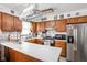 Functional kitchen with classic wood cabinetry, modern appliances, and a practical layout for cooking and meal preparation at 7651 Sherry Ln, Brownsburg, IN 46112