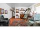 Cozy living room with hardwood floors, traditional furnishings, and ample natural light, exuding comfort and warmth at 7651 Sherry Ln, Brownsburg, IN 46112