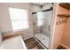 Modern bathroom with tiled shower, glass door, separate tub, and wood-look flooring at 7710 Samuel Dr, Indianapolis, IN 46259