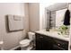A cozy bathroom with a toilet, vanity, sink, and shower at 7710 Samuel Dr, Indianapolis, IN 46259