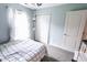 Airy bedroom with bright light, carpeted floor, and white closet doors at 7710 Samuel Dr, Indianapolis, IN 46259