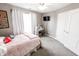 A bedroom featuring gray carpet, a window, and light pink bedding at 7710 Samuel Dr, Indianapolis, IN 46259