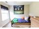 Bedroom with window, dresser, and football stadium art at 7710 Samuel Dr, Indianapolis, IN 46259