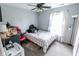 Neutral toned bedroom with ceiling fan, and natural light, featuring a grid patterned bedspread at 7710 Samuel Dr, Indianapolis, IN 46259