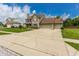 Spacious two-story home with a wide driveway, attached two-car garage, and well-kept lawn at 7710 Samuel Dr, Indianapolis, IN 46259
