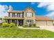 Charming two-story brick home featuring a manicured lawn, covered porch, and attached two-car garage at 7710 Samuel Dr, Indianapolis, IN 46259