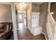 Entryway with a coat rack, wooden floors, and stairway to the upper level at 7710 Samuel Dr, Indianapolis, IN 46259