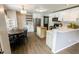 Bright kitchen with white cabinets, stainless steel appliances, island, and adjacent dining area at 7710 Samuel Dr, Indianapolis, IN 46259