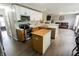 Well-lit kitchen offering white cabinetry, stainless steel appliances, and a functional kitchen island at 7710 Samuel Dr, Indianapolis, IN 46259