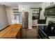 Bright kitchen featuring stainless steel refrigerator, white cabinetry and pantry at 7710 Samuel Dr, Indianapolis, IN 46259