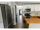 Galley kitchen with stainless steel refrigerator and modern cabinetry at 7710 Samuel Dr, Indianapolis, IN 46259