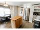 Kitchen with stainless steel appliances, island, and adjacent dining area with natural lighting at 7710 Samuel Dr, Indianapolis, IN 46259