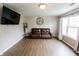 Comfortable living room featuring modern flooring, neutral walls, and a comfortable leather sofa at 7710 Samuel Dr, Indianapolis, IN 46259