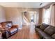 Open-concept living room with hardwood floors, comfortable seating, and a staircase in the background at 7710 Samuel Dr, Indianapolis, IN 46259