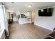 Open concept living room with bright white kitchen and modern hard wood flooring at 7710 Samuel Dr, Indianapolis, IN 46259