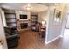 Cozy living room with a brick fireplace, built-in shelving, and hardwood floors at 7710 Samuel Dr, Indianapolis, IN 46259
