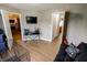 Comfortable living room with television, hardwood floors and adjacent rooms at 7710 Samuel Dr, Indianapolis, IN 46259