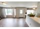 Bright living area with hardwood floors, windows, a white door, and ample natural light at 7710 Samuel Dr, Indianapolis, IN 46259