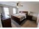Primary bedroom features large bed, ceiling fan, carpeting, and abundant natural light at 7710 Samuel Dr, Indianapolis, IN 46259
