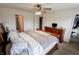 Spacious Primary bedroom with ceiling fan, carpeting, and an ensuite bathroom at 7710 Samuel Dr, Indianapolis, IN 46259