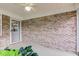 Covered back porch with brick accents and a storm door entrance at 7911 Bentley Commons Dr, Indianapolis, IN 46259