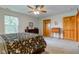 Comfortable bedroom with plush carpet, windows, and wood furniture at 7911 Bentley Commons Dr, Indianapolis, IN 46259