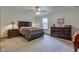 Cozy bedroom with wood furniture, ceiling fan, and ample natural light at 7911 Bentley Commons Dr, Indianapolis, IN 46259