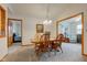 Bright dining room with wood furniture and access to living and bedrooms at 7911 Bentley Commons Dr, Indianapolis, IN 46259
