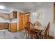 Adjacent dining space with wood floors, cabinet, and chairs at 7911 Bentley Commons Dr, Indianapolis, IN 46259