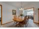 Elegant dining room with wood floors, flower centerpiece, and chandelier lighting at 7911 Bentley Commons Dr, Indianapolis, IN 46259