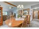 Open concept dining area with wood table and chairs, connecting to the living room and kitchen at 7911 Bentley Commons Dr, Indianapolis, IN 46259