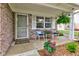Cozy front porch with seating, potted flowers, and charming details, creating a welcoming entrance at 7911 Bentley Commons Dr, Indianapolis, IN 46259