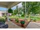 Inviting front porch view showcases manicured lawn, decorative plants, and a relaxing outdoor seating area at 7911 Bentley Commons Dr, Indianapolis, IN 46259