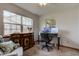 Bright home office featuring a desk, monitors, and a large window providing ample natural light at 7911 Bentley Commons Dr, Indianapolis, IN 46259