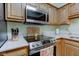 This kitchen features stainless steel microwave and oven with a white countertop at 7911 Bentley Commons Dr, Indianapolis, IN 46259