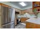 Well-lit kitchen with wood cabinets, stainless steel appliances, and light countertops at 7911 Bentley Commons Dr, Indianapolis, IN 46259
