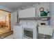 Bright laundry room with washer, dryer, cabinets, and utility sink at 7911 Bentley Commons Dr, Indianapolis, IN 46259