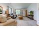 Inviting living room with plush seating, natural light, and a view of the front yard at 7911 Bentley Commons Dr, Indianapolis, IN 46259