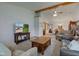 Comfortable living room featuring a large TV, ceiling fan, and an open layout to the dining room at 7911 Bentley Commons Dr, Indianapolis, IN 46259